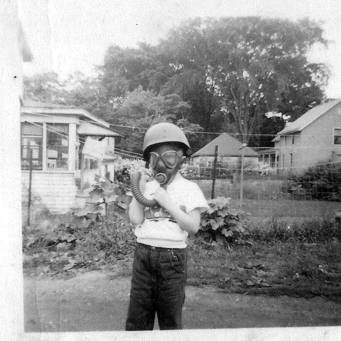 author as a child with helmet and
gas mask